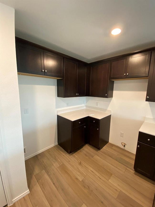 Kitchen with baseboards, light countertops, light 