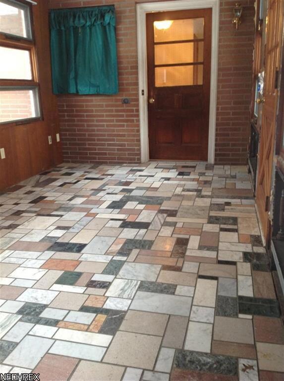 Marble tiled sun room opens to back patio on the l