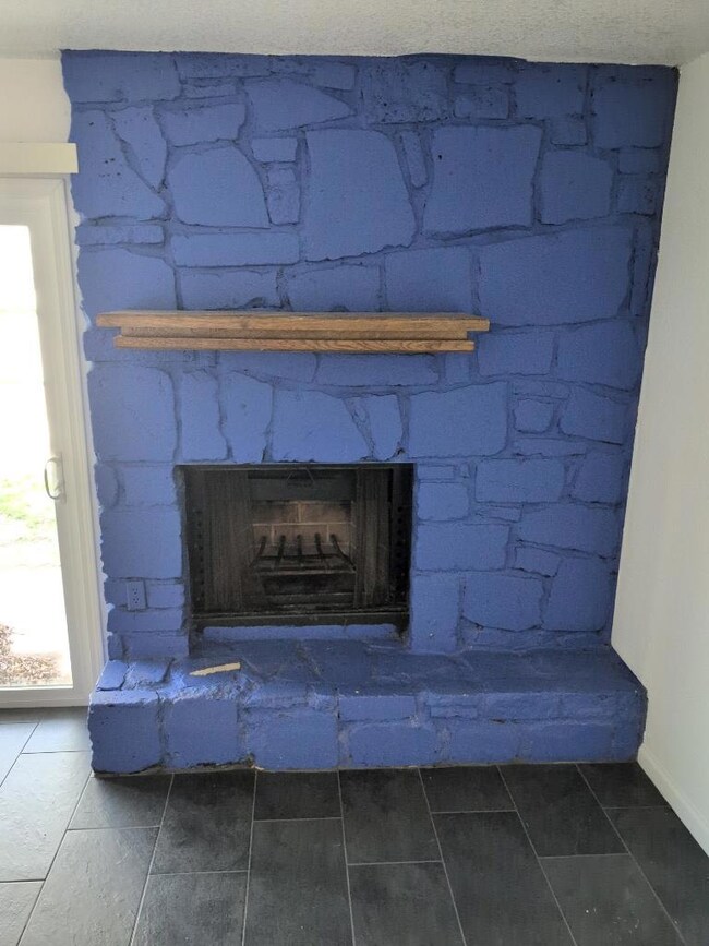 Interior details featuring a large fireplace