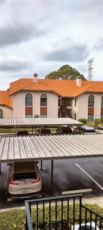 View of carport and building a cros