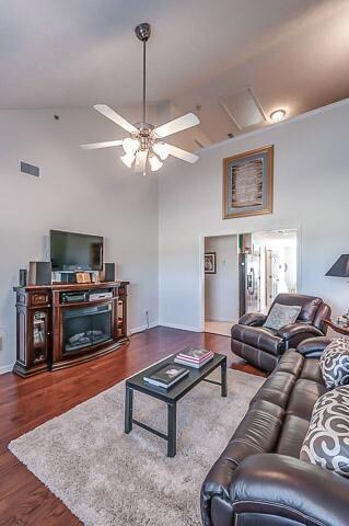This view shows not only the wide entrance to the Kitchen and points beyond, but also the upper level Loft just beyond the ceiling fan that is open to the lower area!