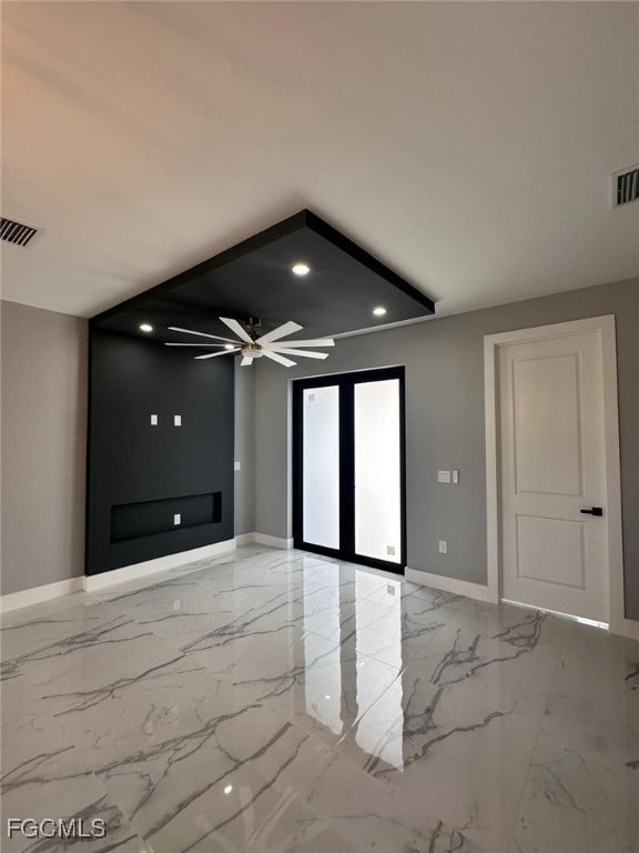 Empty room featuring light marble finish floors, recessed lighting, and ceiling fan