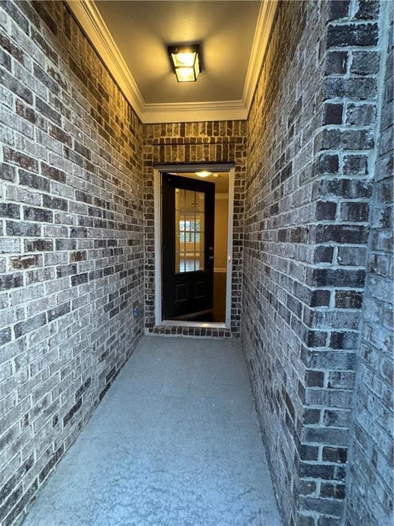 Property entrance featuring brick siding