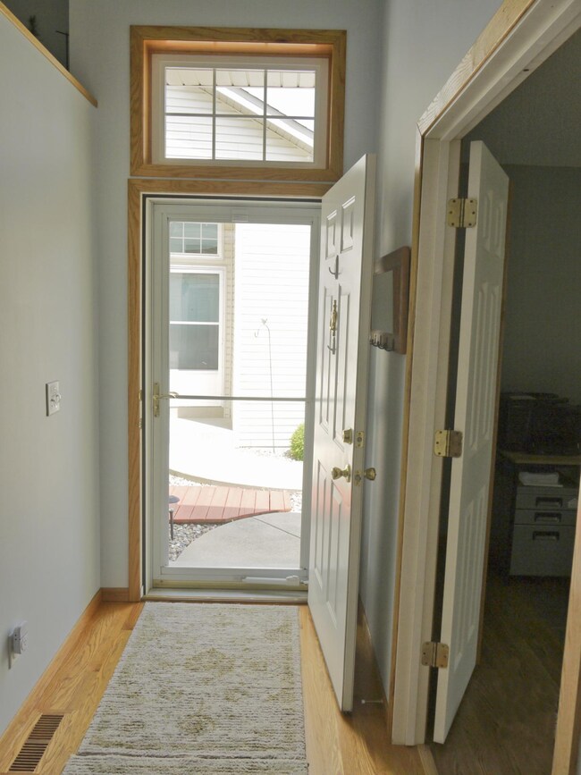 Entry foyer with oak flooring,  large transom window and office access