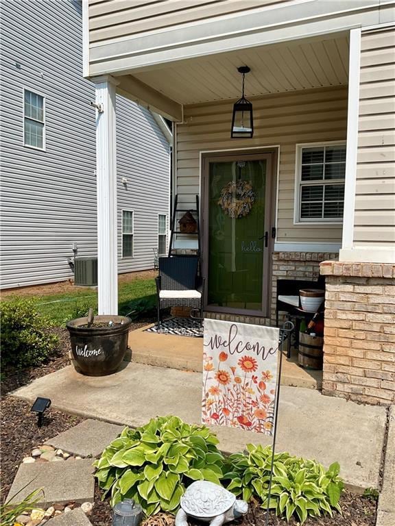 View of exterior entry with a porch and cooling unit