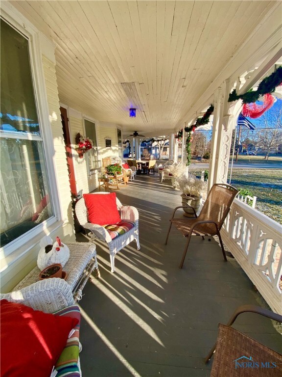 The wrap around porch has ceiling fan and porch sw