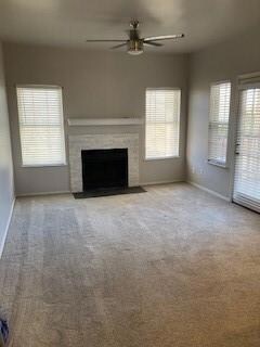 Unfurnished living room with a wealth of natural light and light colored carpet