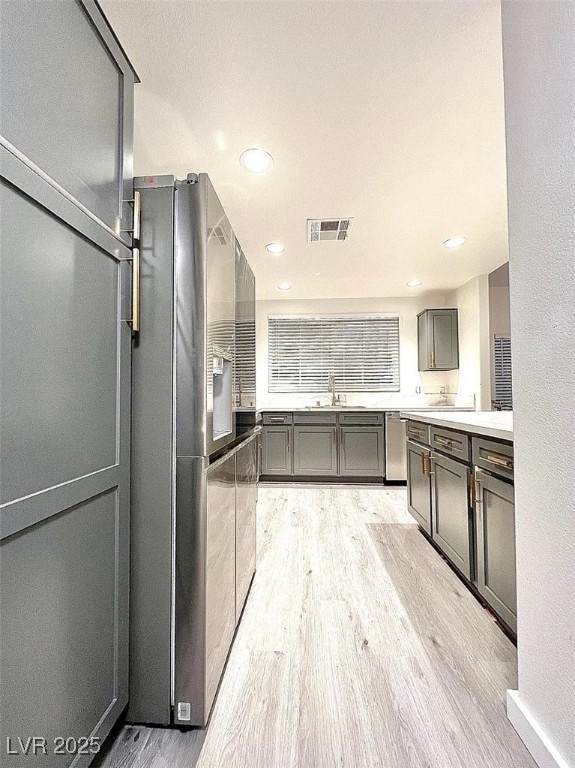 Kitchen with light wood-style flooring, gray cabin