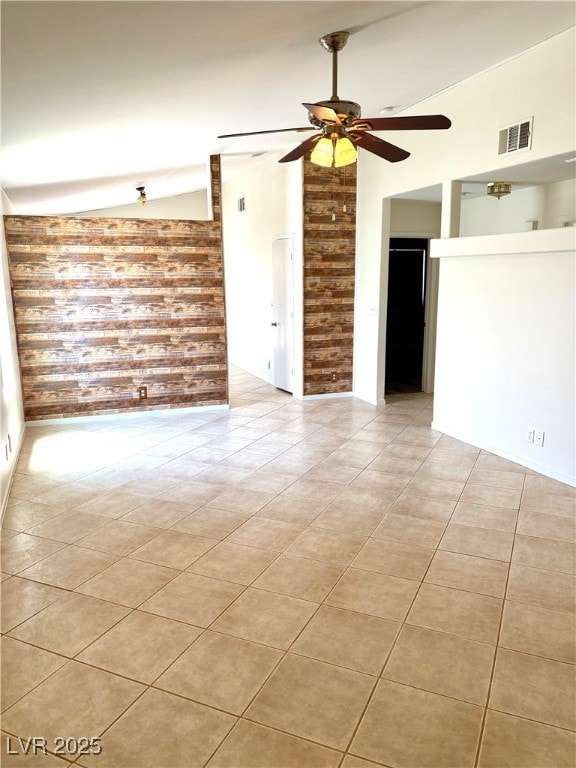 Spare room with vaulted ceiling, a ceiling fan, an