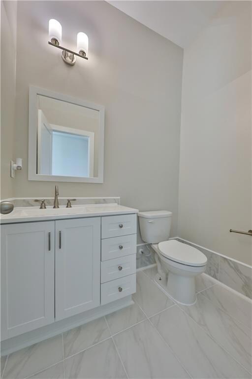 Bathroom featuring vanity and toilet