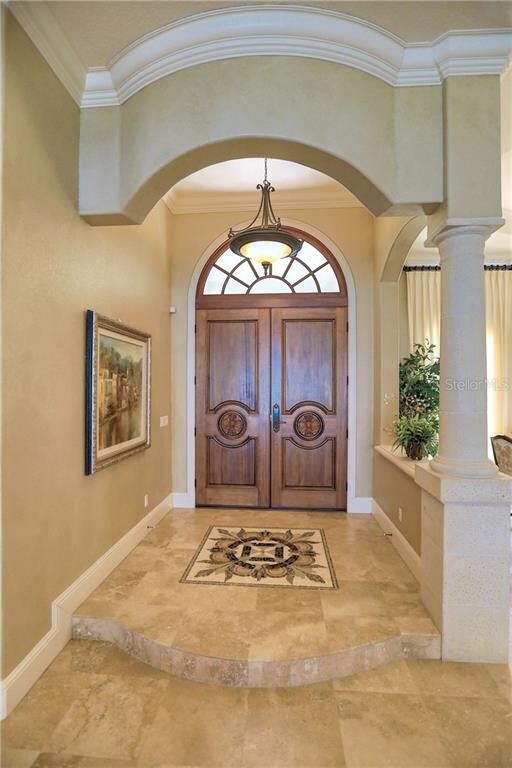 Front entry with inlaid mosaic tile and travertine