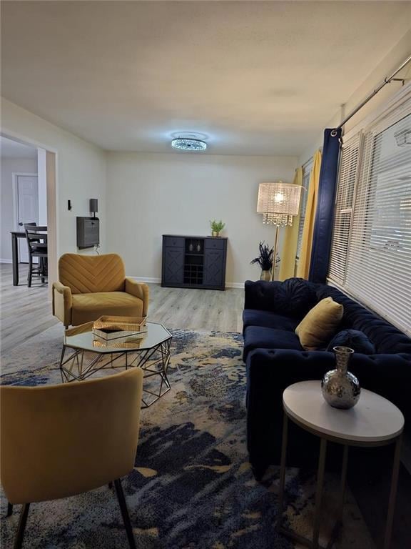 Living room with baseboards and wood finished floo