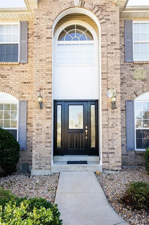 Property entrance featuring brick siding