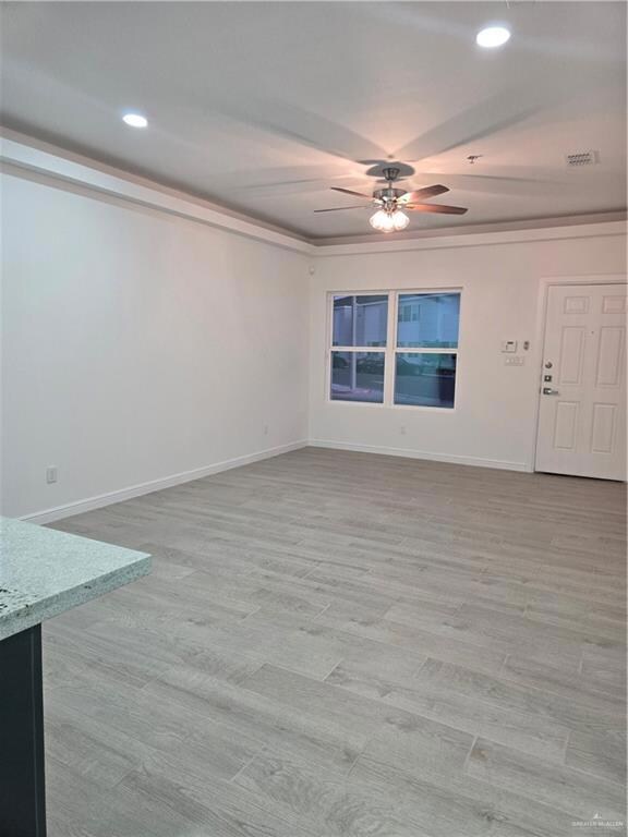 Empty room with ceiling fan and crown molding