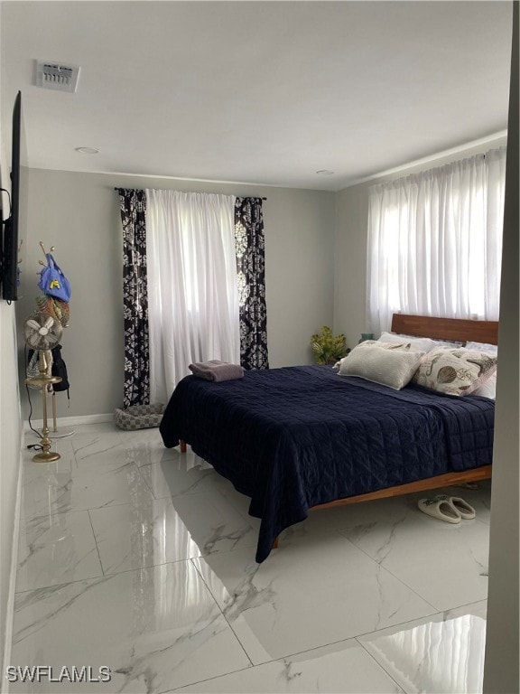 Bedroom with marble finish flooring