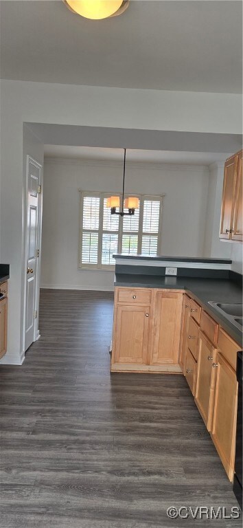 Kitchen featuring LVP flooring, pendant lighting, a notable chandelier, and light brown cabinets
