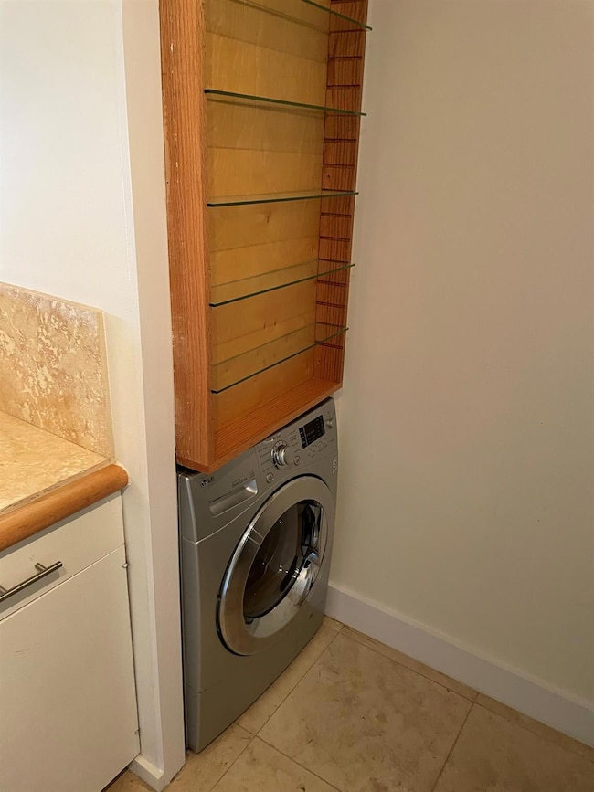 Laundry room with light tile patterned flooring, 