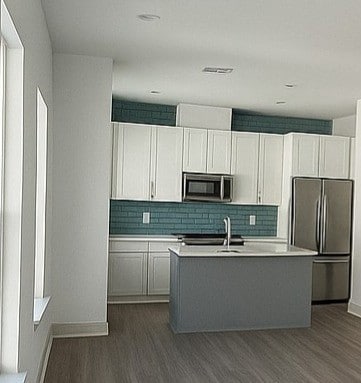 Large windows fill the space with natural light, highlighting the sleek finishes, modern fixtures, and inviting neutral tones.