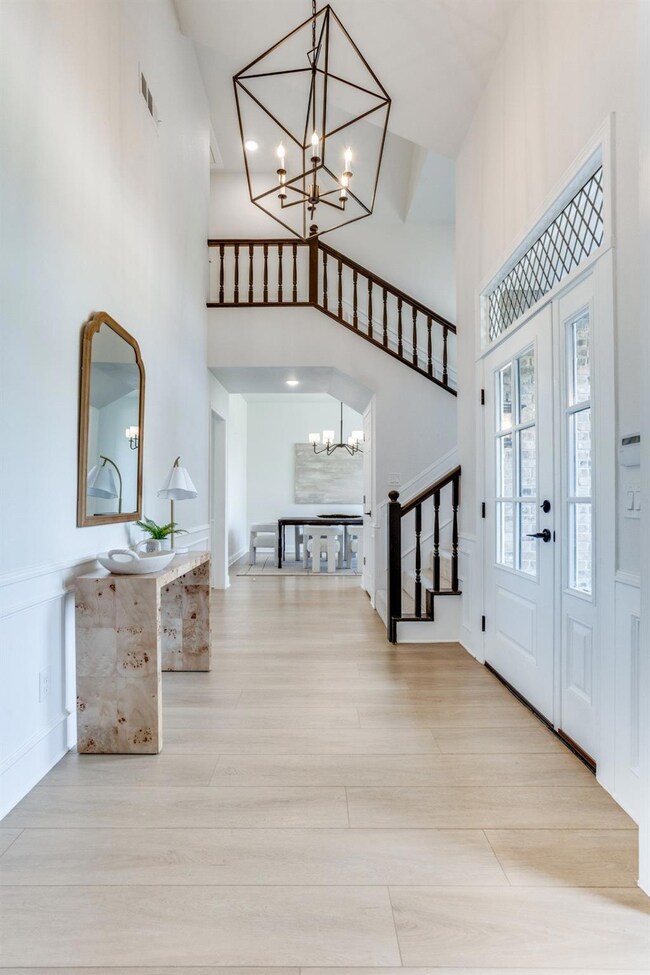 Entryway featuring a high ceiling, light hardwood 