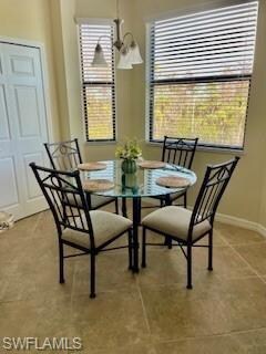 Dining space with tile patterned floors and baseboards
