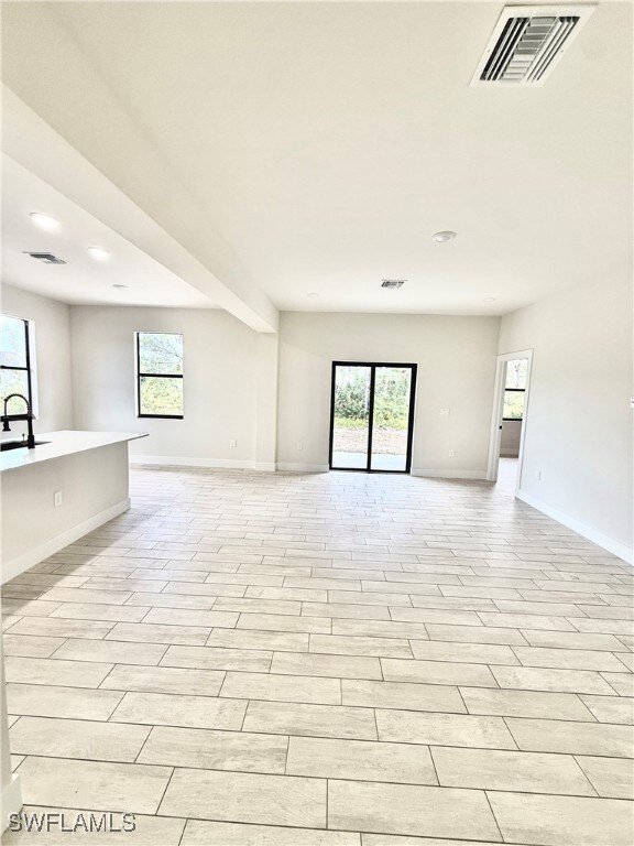 Living room with baseboards, recessed lighting, a