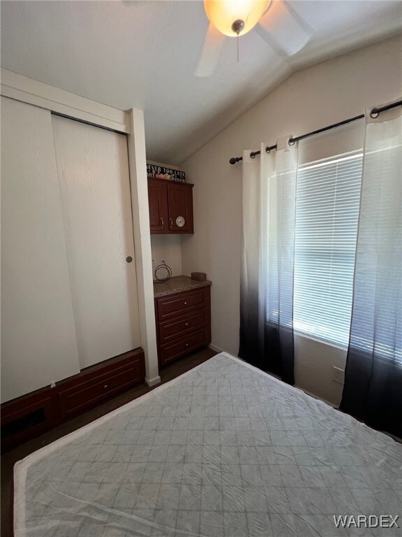 Unfurnished bedroom with a closet, ceiling fan, an