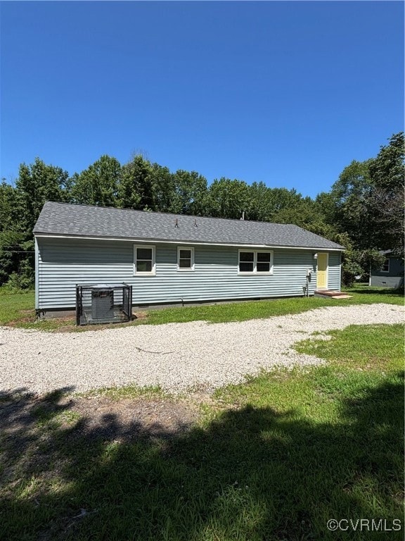 Back of property with a yard
