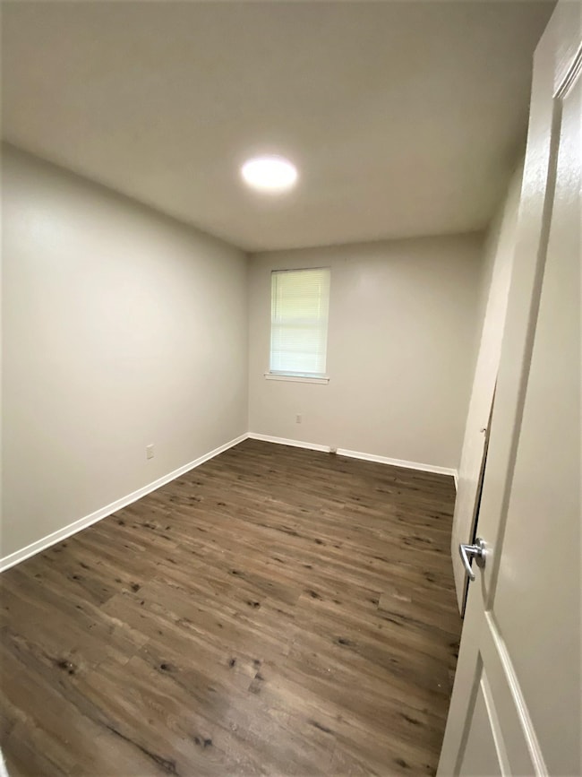 Spare room featuring dark hardwood / wood-style fl