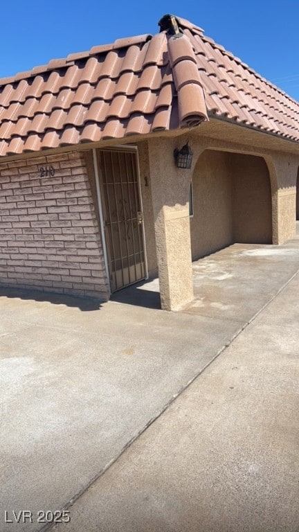 View of exterior entry featuring concrete driveway