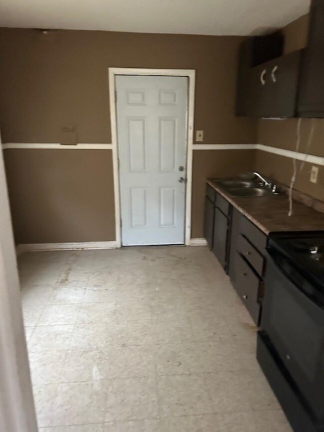 Kitchen featuring dark brown cabinets, sink, and e