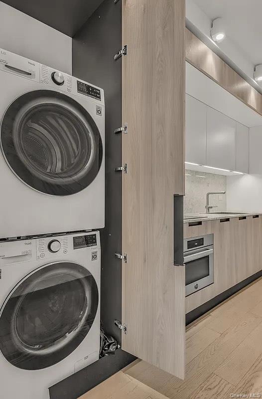 Laundry area with estacked washer and dryer