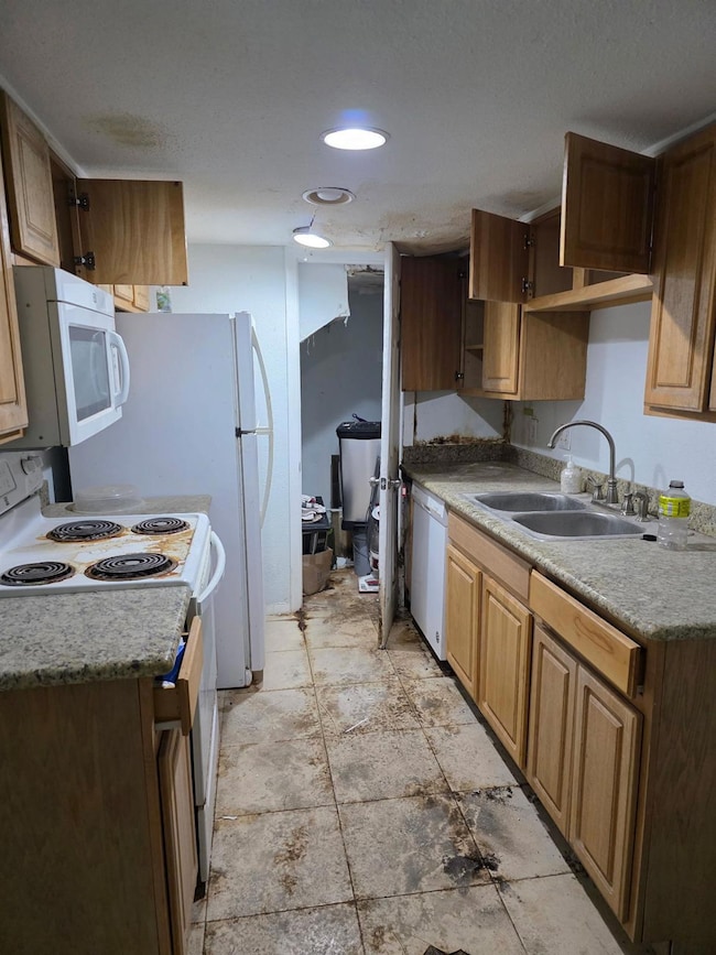 Kitchen featuring white appliances, open shelves,