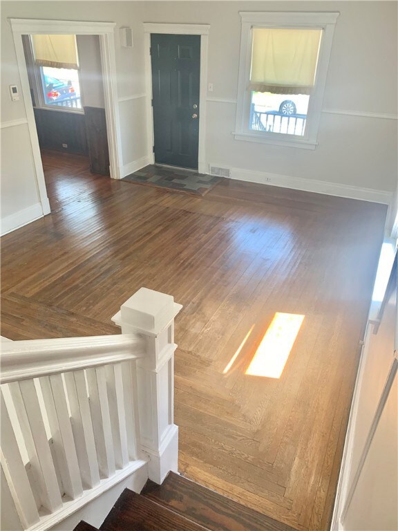 A VIEW OF THE LIVING ROOM FROM THE STAIRS COMING D
