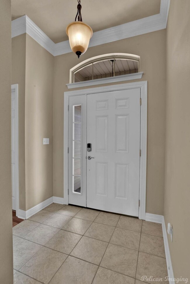 Foyer entrance featuring light tile patterned floo