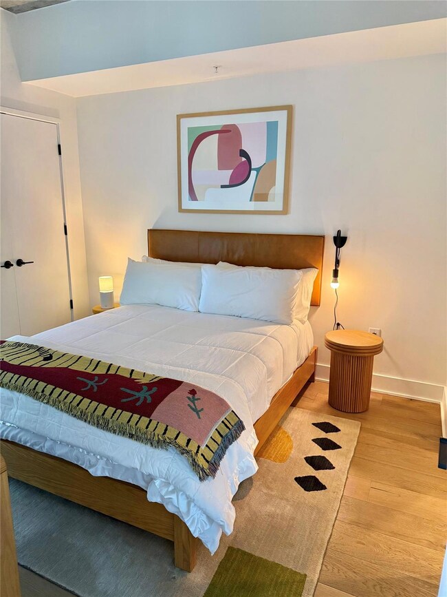 Bedroom featuring wood finished floors and baseboards