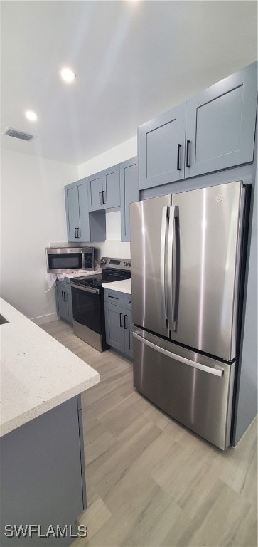 Kitchen featuring light stone countertops, visible