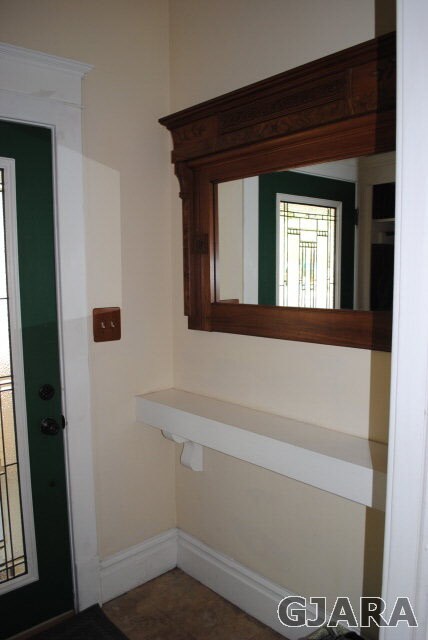 Air lock entry with mantel, mirror and closet.