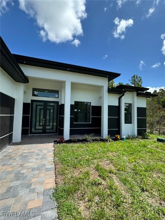 Rear view of house with stucco siding