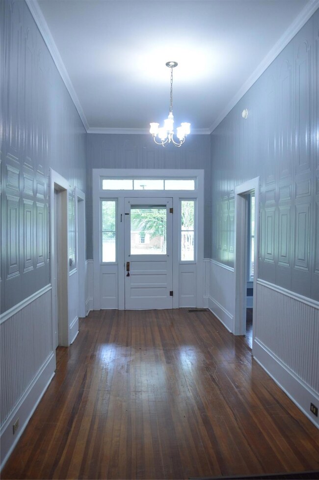 Entryway with crown molding, a wealth of natural l