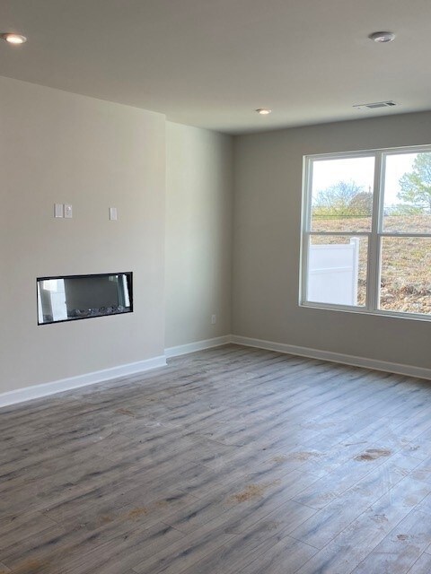 Cozy fireplace in the family room that is open to the kitchen