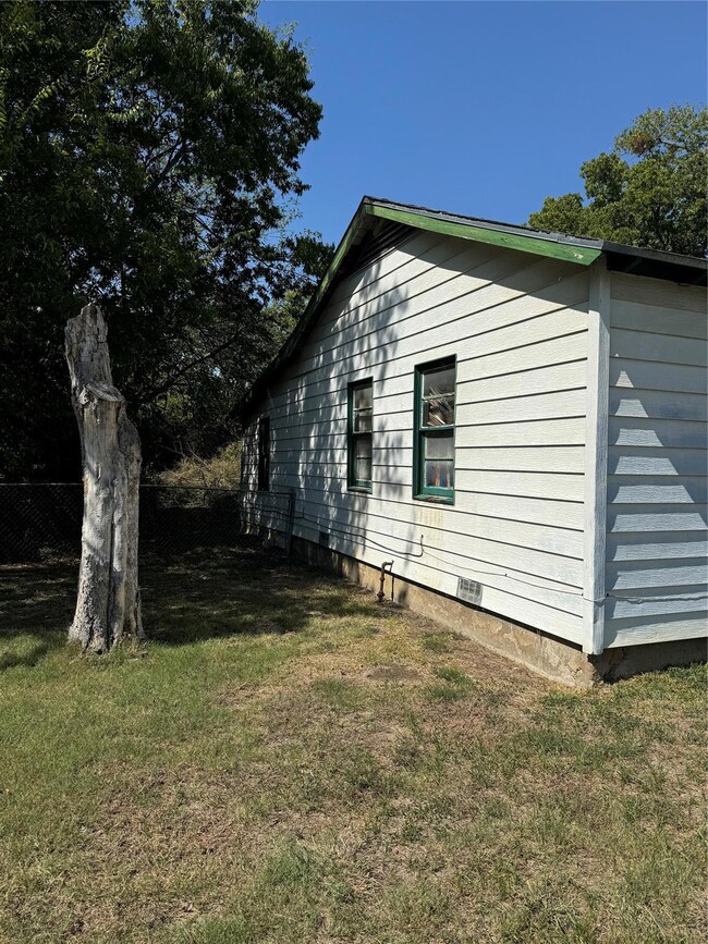 View of side of property with a lawn