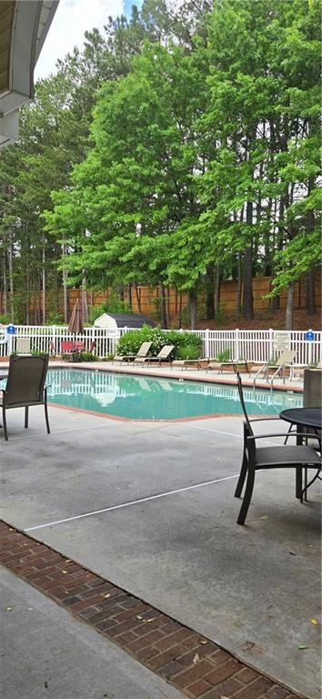 View of pool with a fenced in pool, a patio area, 