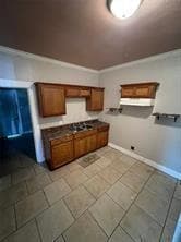 Kitchen featuring dark countertops, brown cabinetr