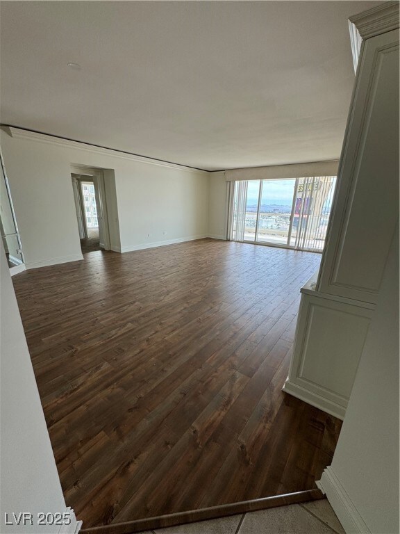 Spare room featuring plenty of natural light, dark
