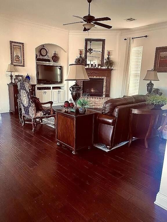 Unfurnished living room with crown molding, a bric