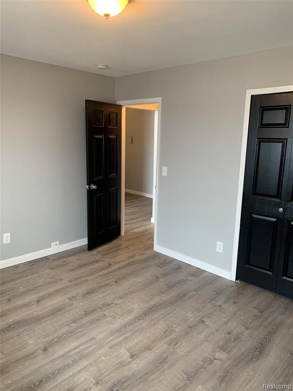 Spare room with wood finished floors and baseboards