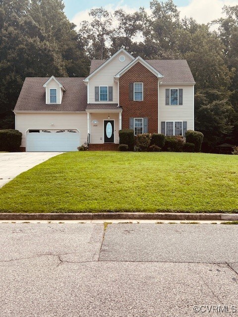 View of front of home featuring a garage and a fro