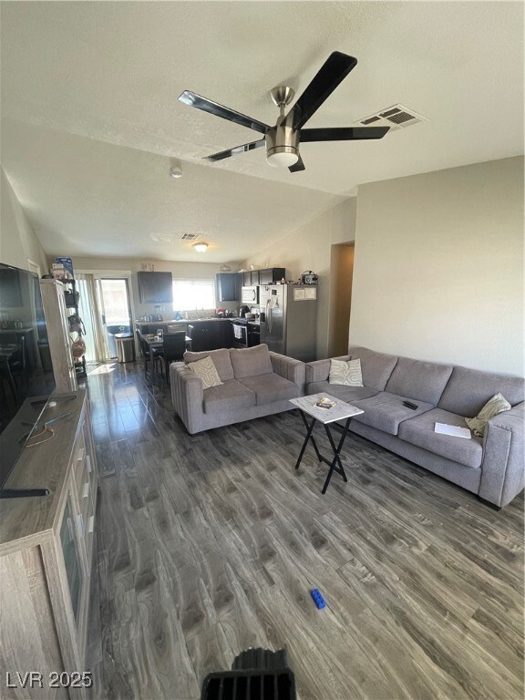 Living area featuring dark wood-style flooring, a