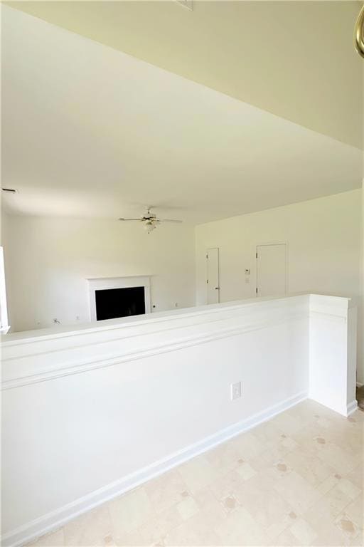 View from Eat In Kitchen to family room featuring a ceiling fan and light flooring