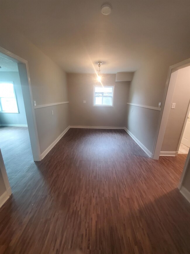 Dining room area with dark wood-type flooring